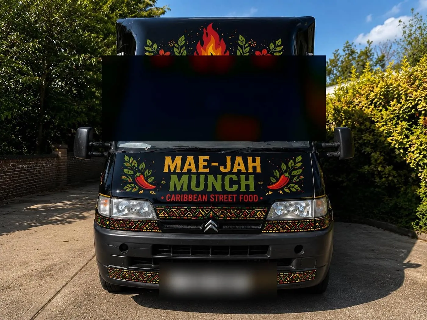 The Mae-Jah Munch food truck, hand-painted with a bold Caribbean folk-art wrap